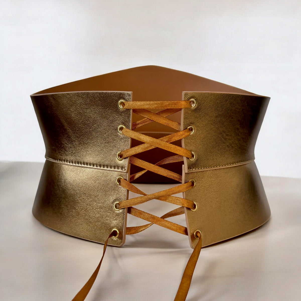 Aria Margo gold Italian leather corset belt with an hourglass silhouette and satin lace-up front closure.