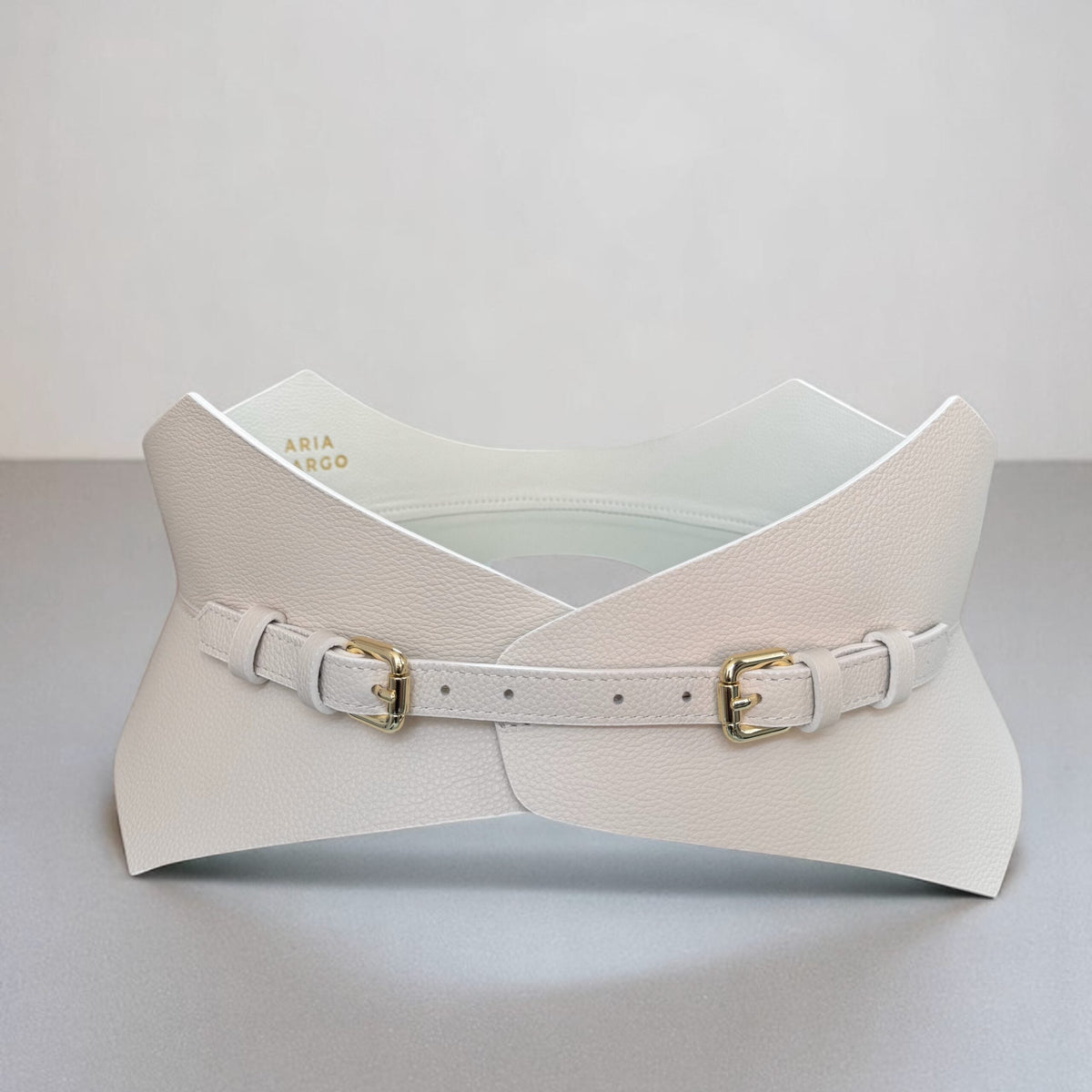 Aria Margo ivory leather corset belt with gold buckles and a pointed silhouette for a flattering waistline.