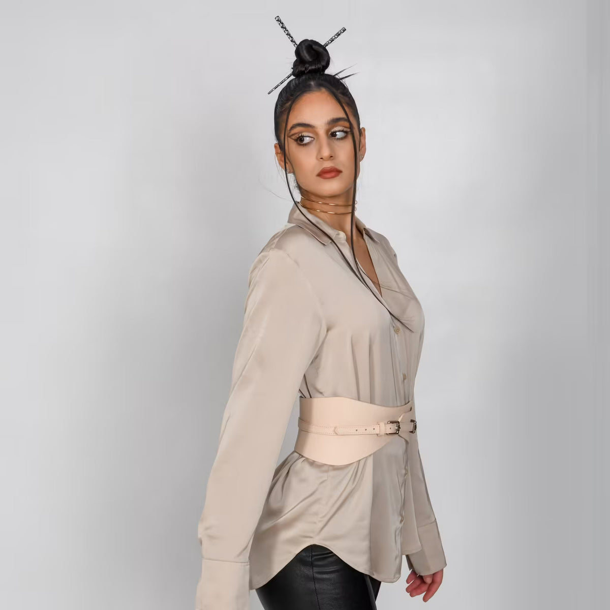Aria Margo beige Italian leather slim corset belt worn over a satin button-down shirt for a structured waist.