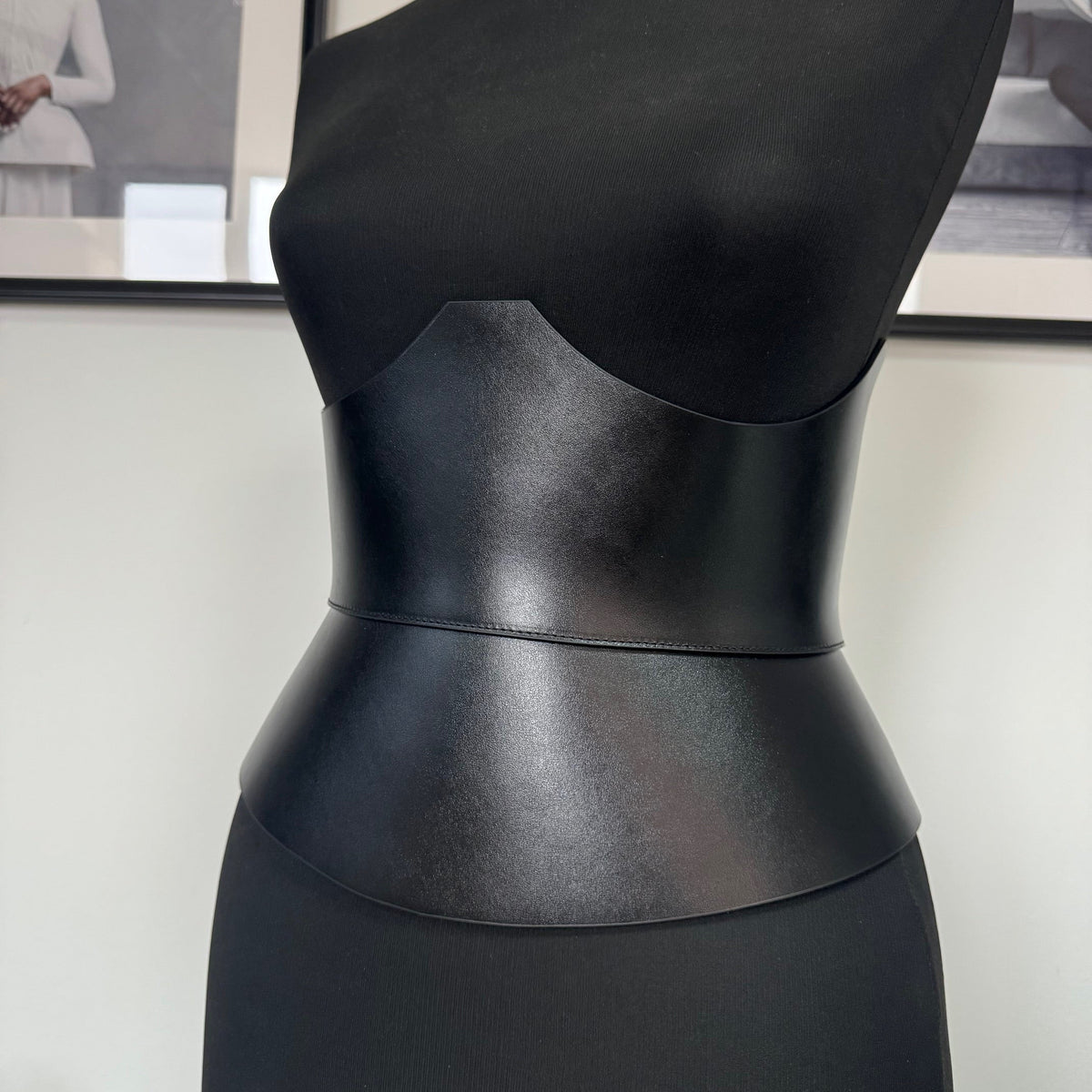 Aria Margo black Italian leather corset belt worn on a mannequin to define the waist and under-bust silhouette.