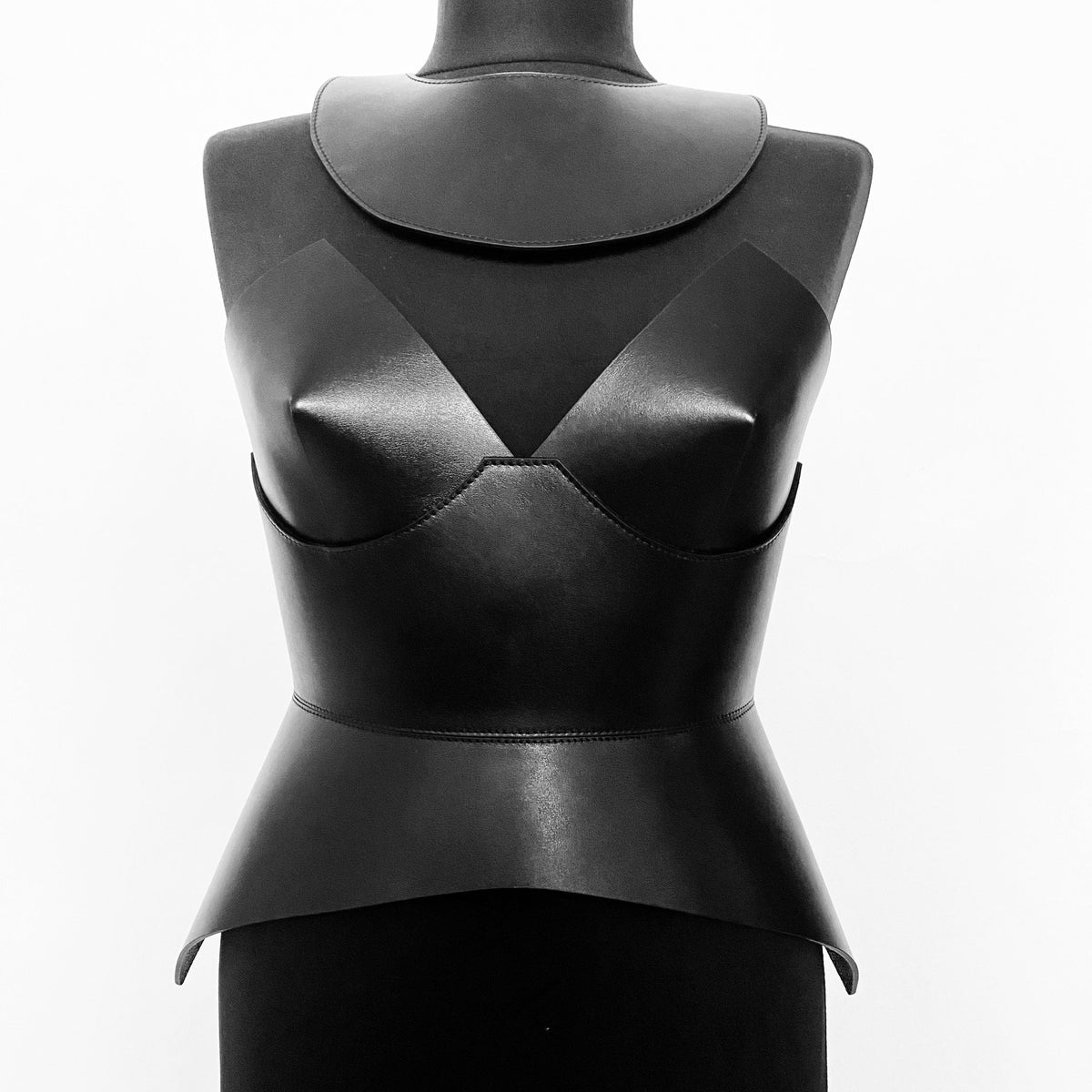 Aria Margo black leather full body corset belt with a structured, minimalist futuristic silhouette on a mannequin.