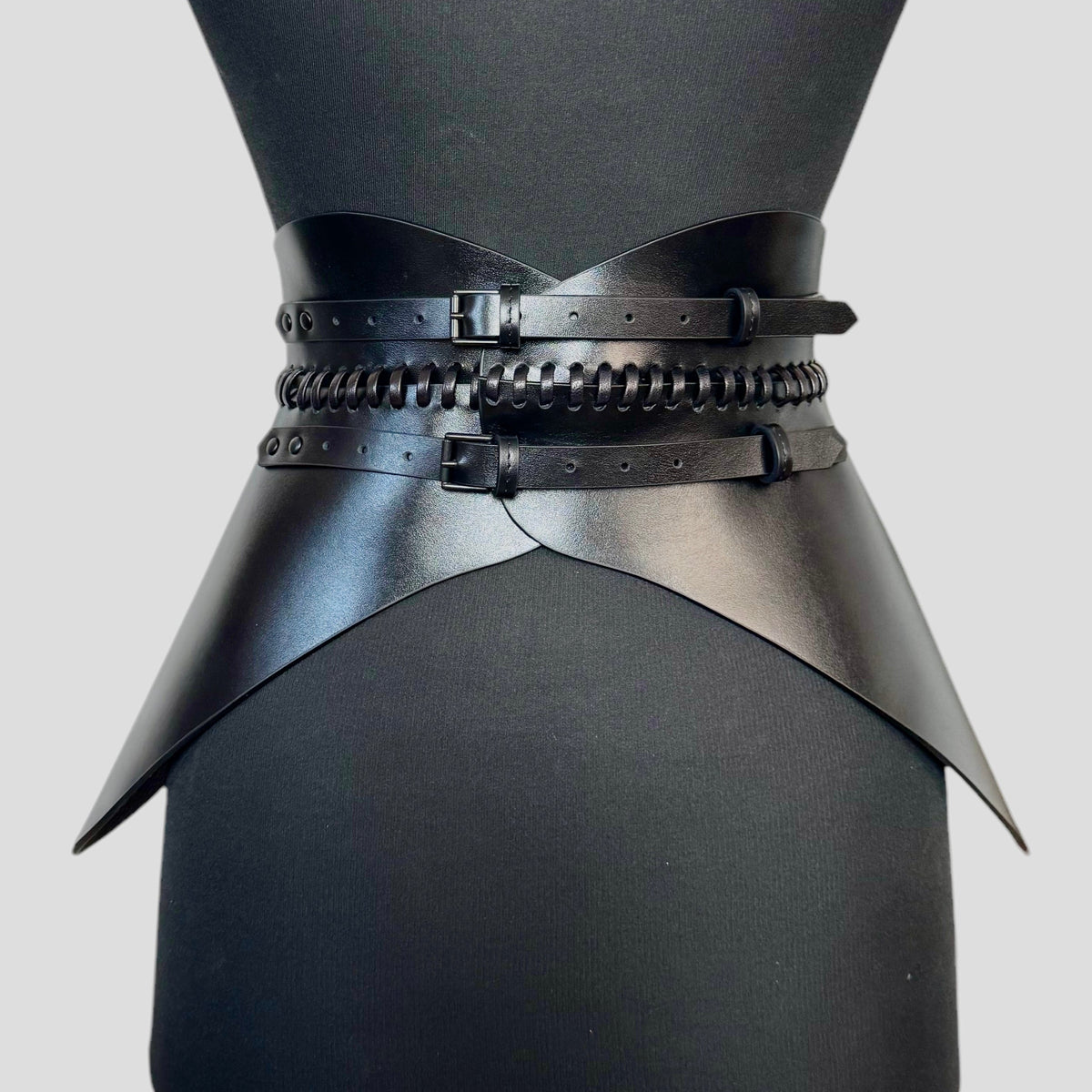 Aria Margo black Italian leather corset belt with hand-worked lacing and adjustable buckles on a mannequin.
