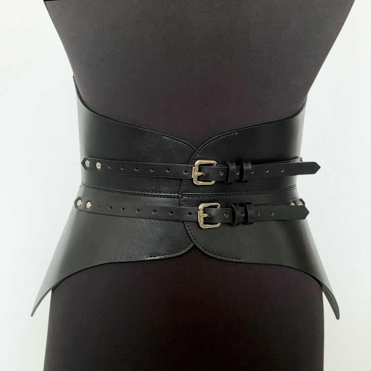 Aria Margo black Italian leather full body corset belt with two polished silver buckles on a mannequin torso.