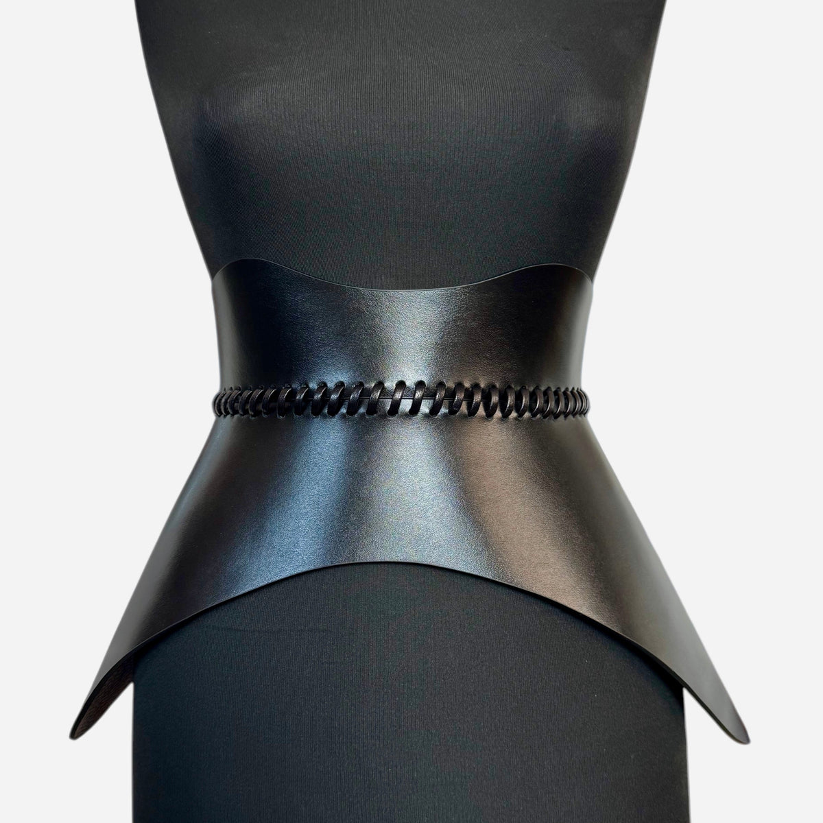 Aria Margo black leather corset belt with hand-worked lacing detail, sculpted for an hourglass silhouette.