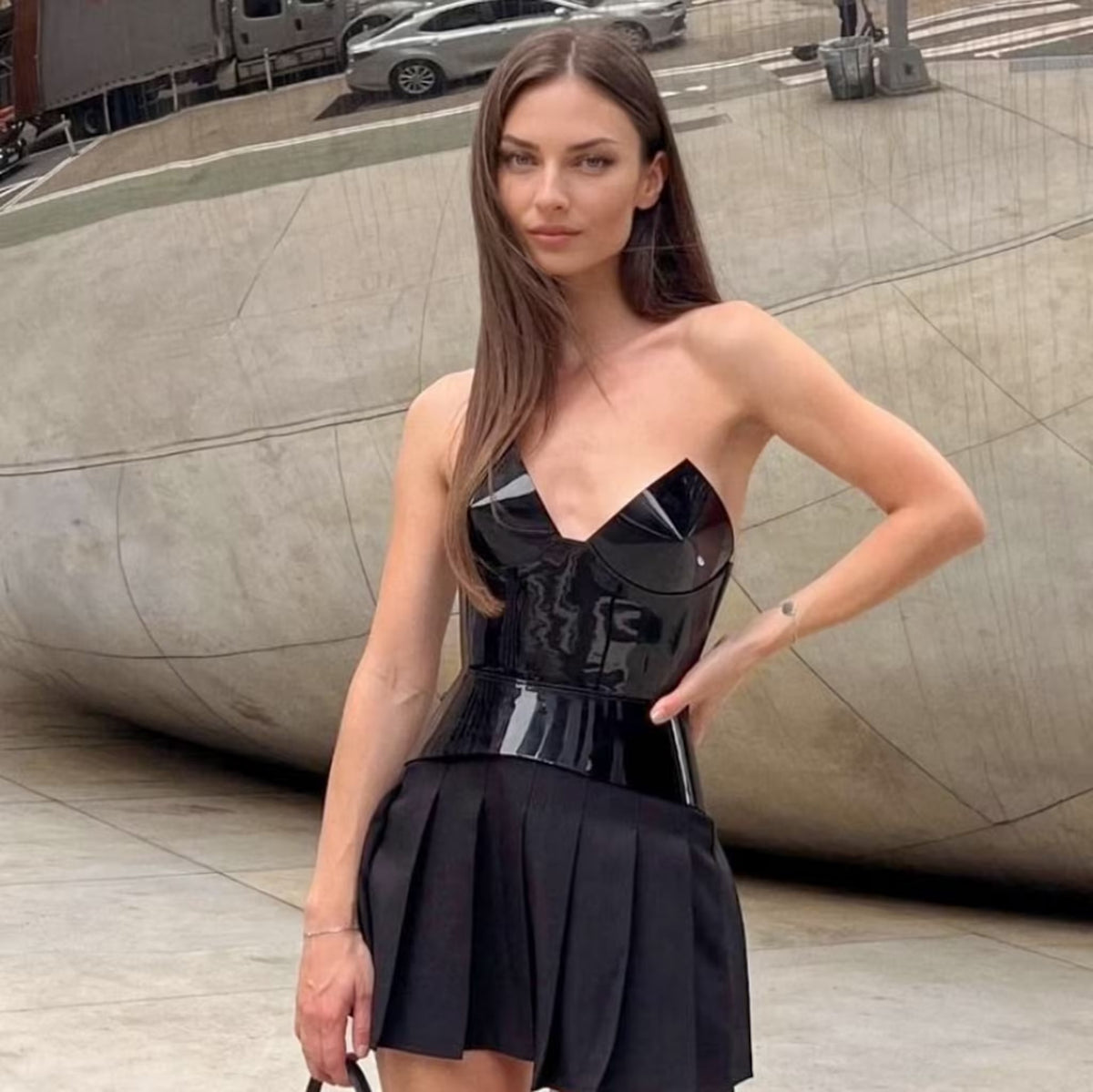 Aria Margo black patent leather corset belt worn by a model, featuring a structured, high-shine finish.