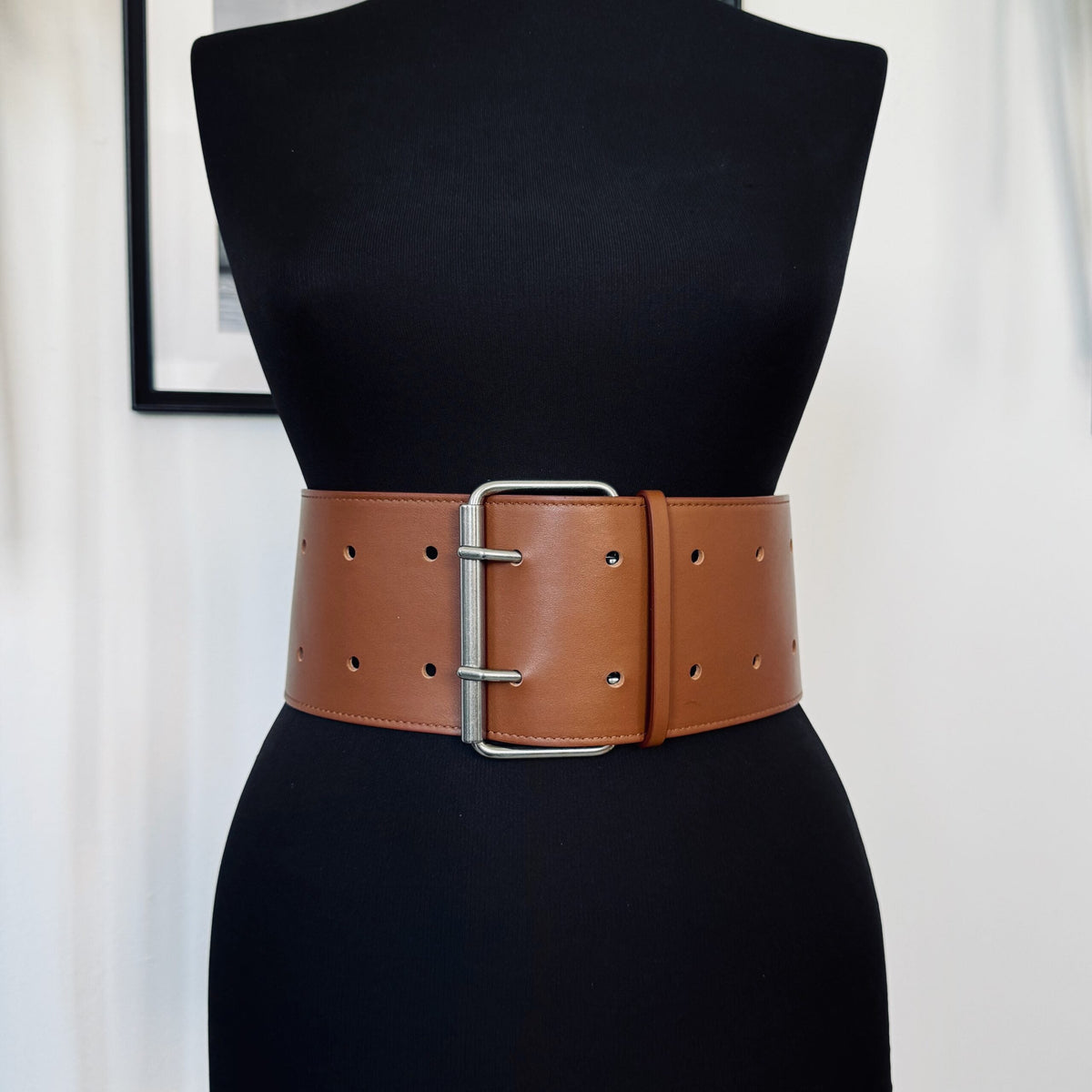 Aria Margo brown Italian leather military coat belt with a silver-tone double-prong buckle on a black mannequin.