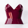 Aria Margo burgundy patent leather round body corset with a high-shine finish and structured feminine silhouette.