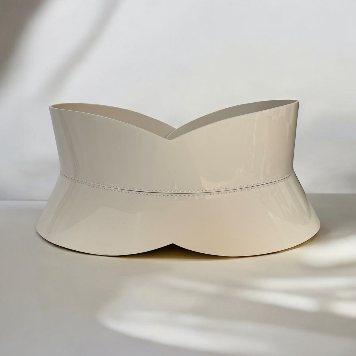 Aria Margo ivory patent leather hourglass corset belt with a high-shine finish and structured silhouette.