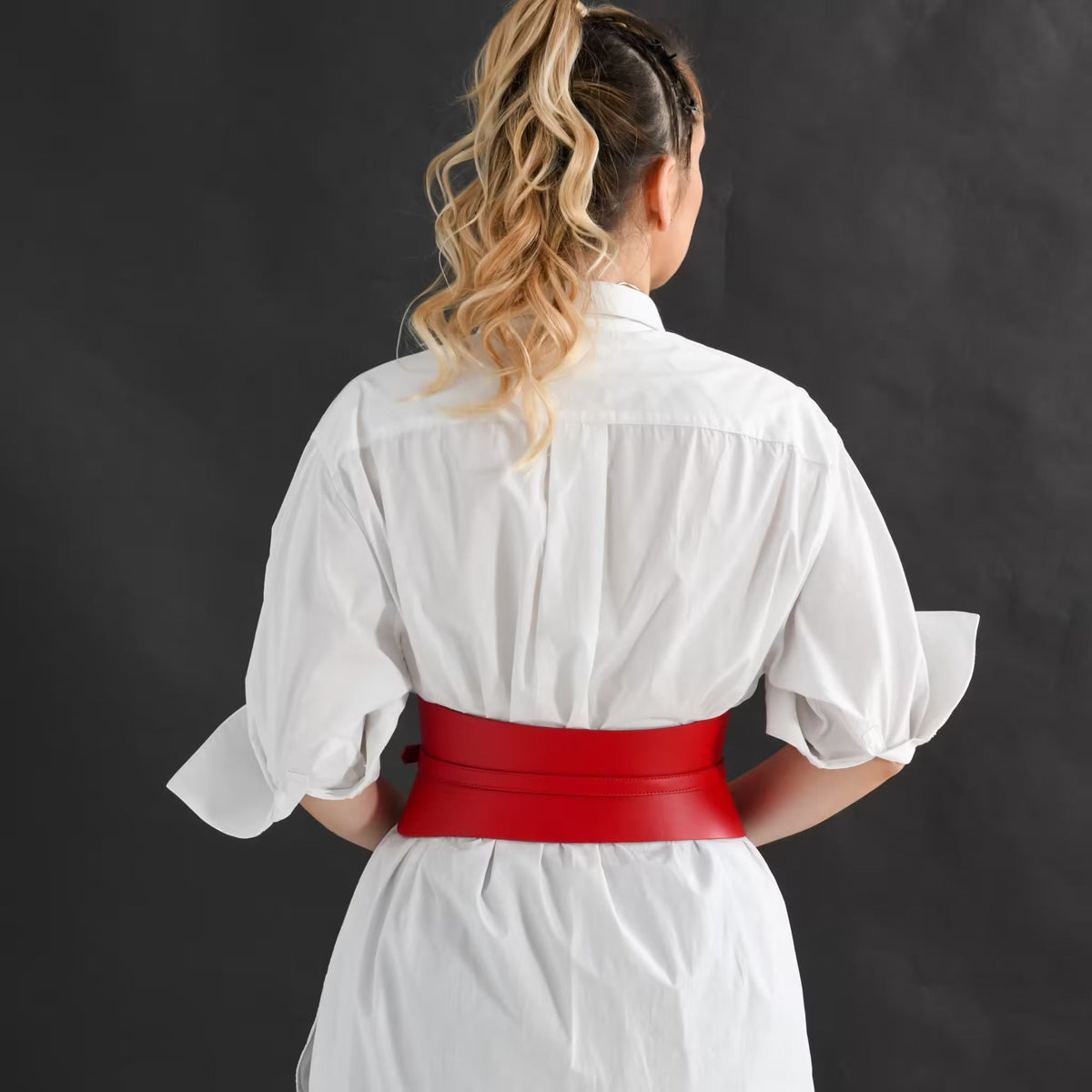 Aria Margo slim red Italian leather corset belt worn over a white shirt, viewed from the back.