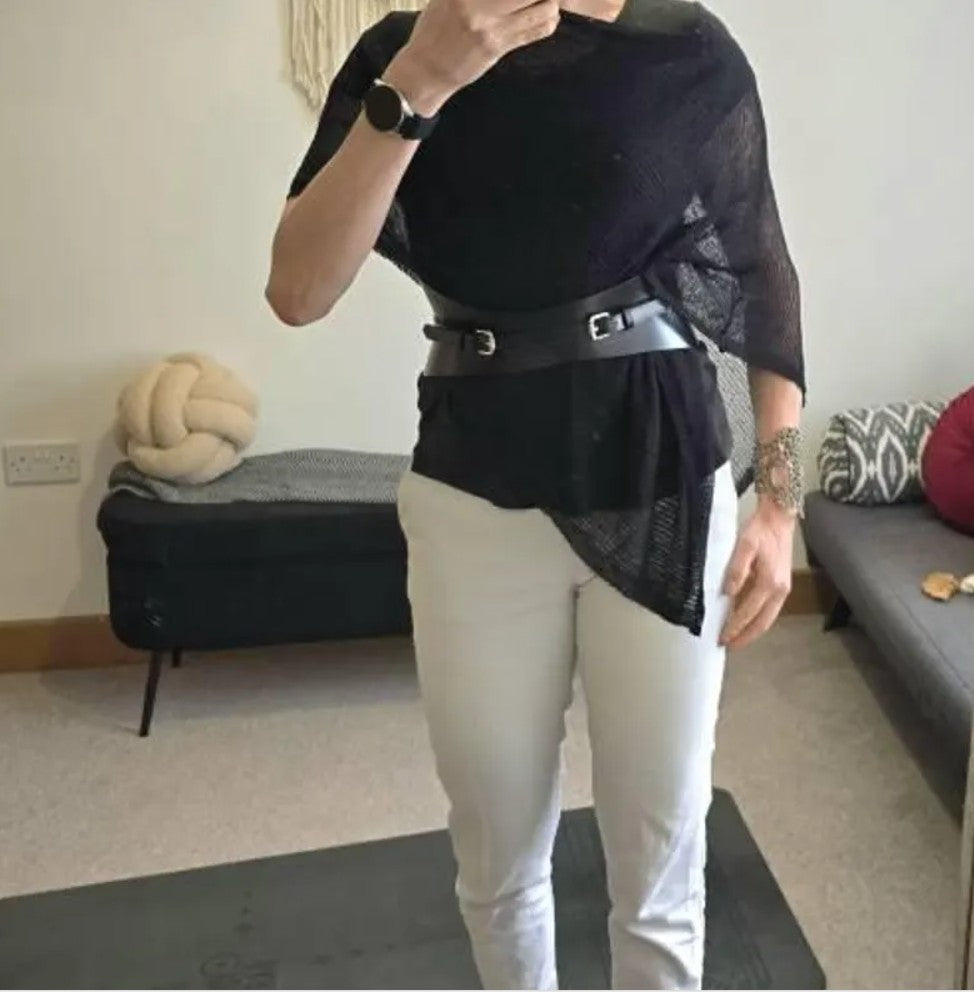 Aria Margo slim black Italian leather corset belt worn over a black top and white trousers