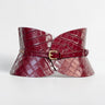 Aria Margo Test burgundy croc-embossed leather hourglass corset belt with a gold buckle on a white background.