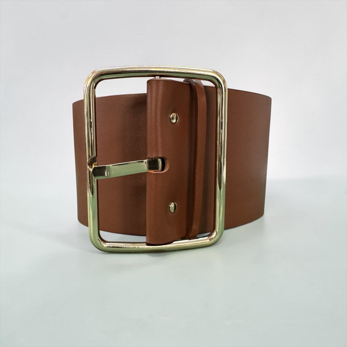 Aria Margo Test oversized brown leather belt featuring a wide 11 cm strap and a large polished gold-tone buckle.
