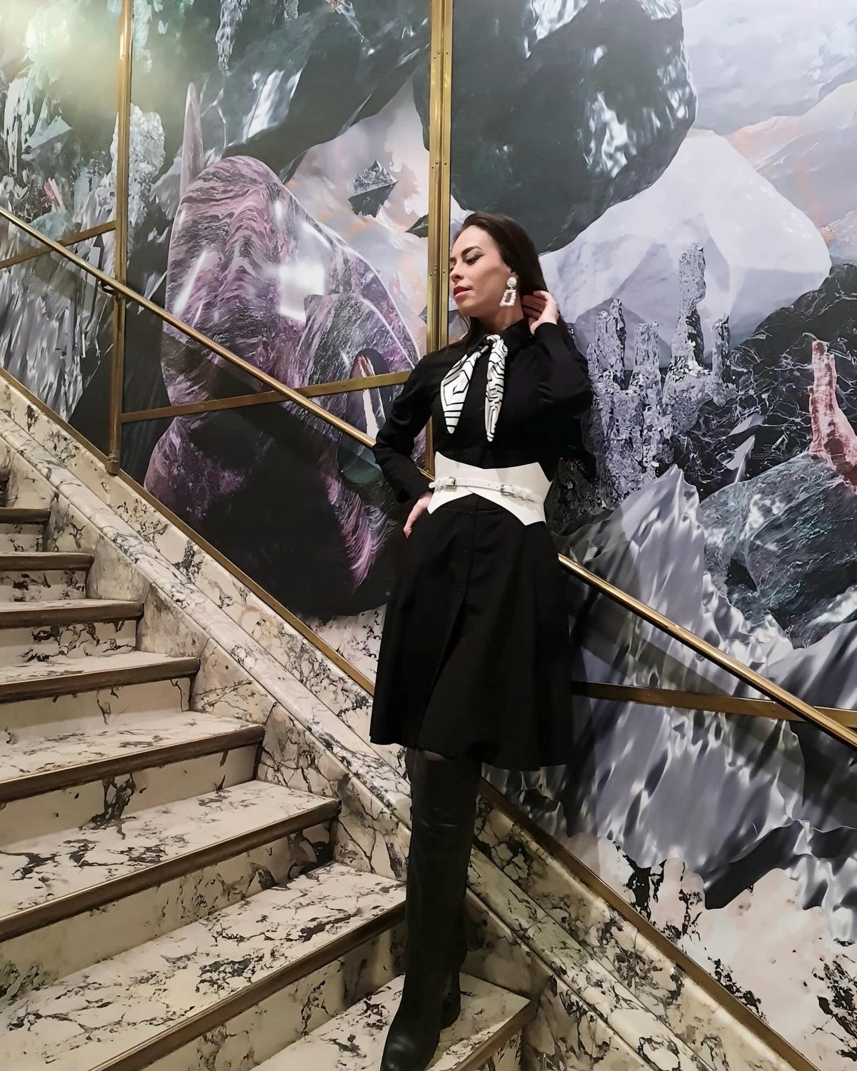 Aria Margo white Italian leather corset belt worn over a black dress on a marble staircase